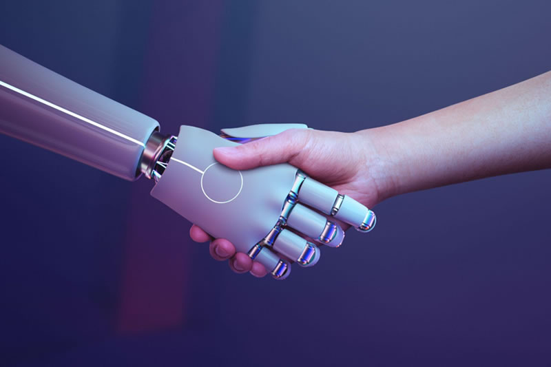 Aperto de mãos entre mão robótica (IA) e mão humana